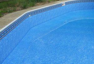 pool liner with a pattern around the rim in a half filled pool, swimspa, endless pool